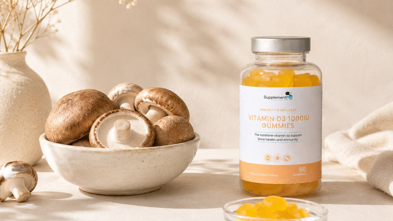 Vitamin D3 gummies beside mushrooms, representing vitamin D2 and vitamin D3 sources